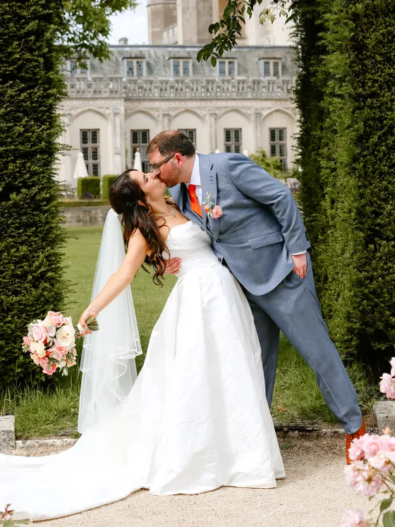 Bride and groom kissing in the garden after their wedding