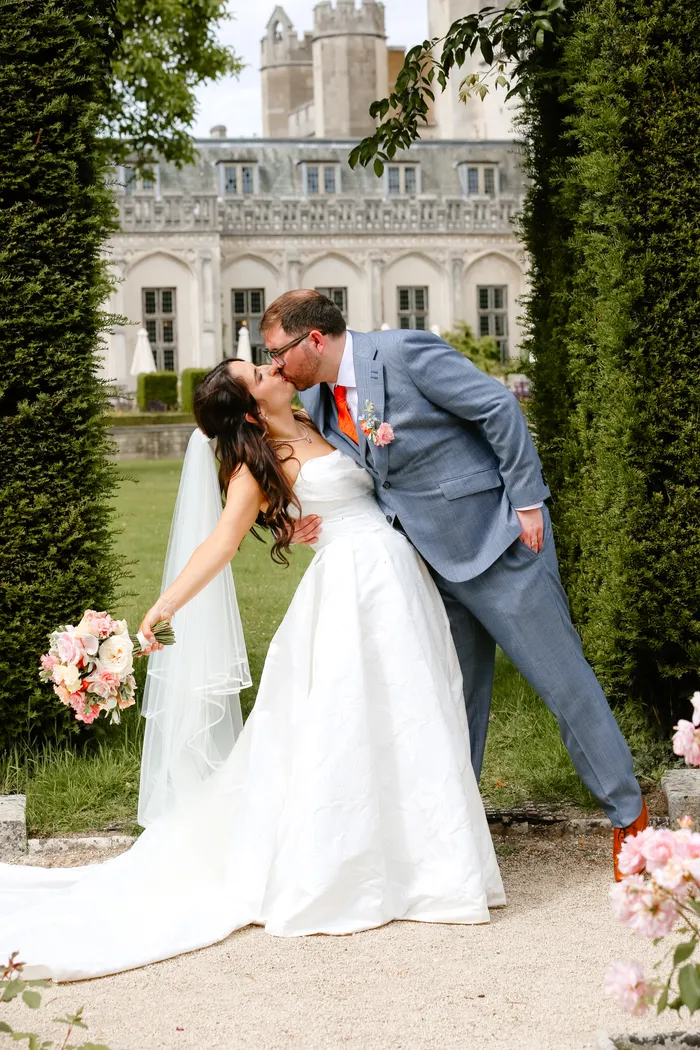 Bride and groom kissing in the garden after their wedding